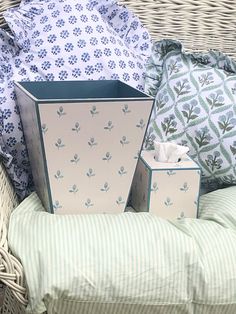 a wicker basket filled with boxes and pillows