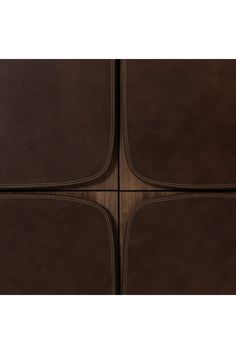 four pieces of brown leather sitting on top of each other