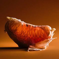 an orange peel that has been peeled and is sitting on a table with brown background