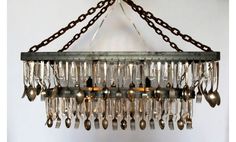 a chandelier with spoons and forks hanging from it