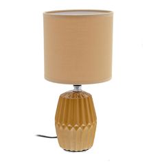 a table lamp with a beige shade on it and a light bulb plugged into the base