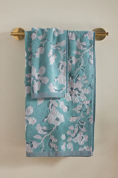 two blue towels hanging on a towel rack