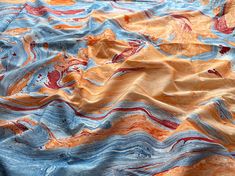 an abstract painting with blue, orange and red colors on it's surface is shown