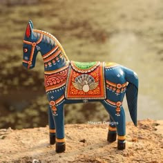 a toy horse is sitting on top of a rock