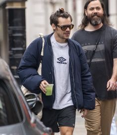 two men are walking down the street together