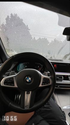 the interior of a car with dashboard, steering wheel and dash board showing through windshield