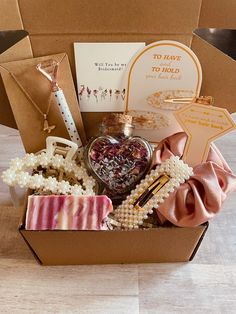 a box filled with lots of different items on top of a wooden table next to a card