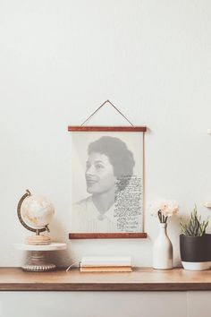 a desk with flowers, books and a framed photograph