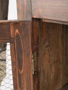 a close up of a wooden table with a wire fence around it