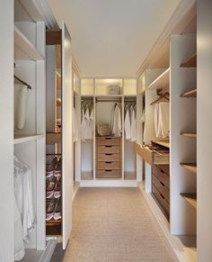 an empty walk in closet with lots of drawers