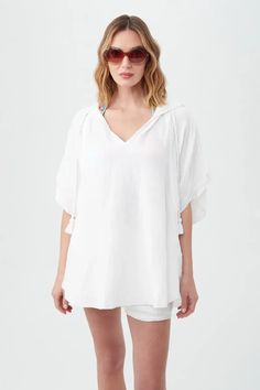 TRINA TURK - $152.00 | This cotton gauze swim cover-up poncho will surely be a new go-to in your swim wardrobe. Featuring a loose fit, breathable cotton, and a hood, this relaxed poncho cover-up is stylish and versatile for beach-to-boardwalk style. #trinaturk #AD #summerfashion Oversized White Cover-up For Loungewear, Casual V-neck Beach Poncho, Beach Tops With Sun Protection And Short Sleeves, Breezy Short Sleeve Tops For Beach Season, Oversized Beach Dress For Summer Loungewear, Short Sleeve Tops With Upf 50+ For Beach, Spring Vacation V-neck Poncho, Upf 50+ Short Sleeve Tops For Beach, Summer Beachwear Tunic For Loungewear