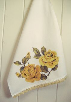 a white towel with yellow roses on it