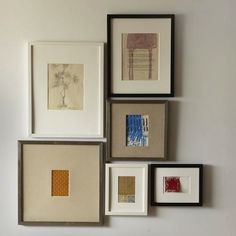 four different framed pictures hanging on the wall