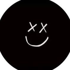 a smiley face drawn on the side of a black round object with two crossed crosses