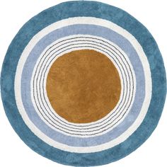 a round rug with blue and brown circles on the center, in front of a white background