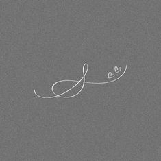 the word love is written in white ink on a gray background with two small hearts