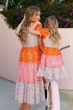 The patchwork dress of your DREAMS now available in bright and bold colors! The Emily Dress features the most fashion forward design, consisting of orange, pink, and stunning floral fabric. She also has an Ivy Favorite smocked bodice, tiered skirt, and dainty puff sleeves. This dress screams, "Ready for Summer" and will be your go-to dress for all your upcoming adventures! Available in size XXS, XS, S, M, L, XL, XXL, 1X, 2X, 3X, 4X, & 5X + kids! Mommy And Me Dress Pattern, Ella Outfit, Worship Leader Outfit, Flora Skirt, Daughter Fashion, Mommy And Me Photo Shoot, Ivy City Co, Mommy And Me Dresses, Stylish Short Dresses