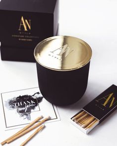 matches are sitting next to a black box with gold foil on it and two matches