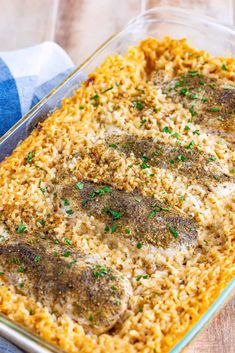 a casserole dish filled with rice and meat