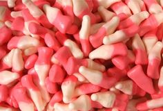 pink and white candies are piled together