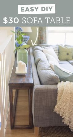 a living room with a couch, coffee table and vase on the end tables in front of it