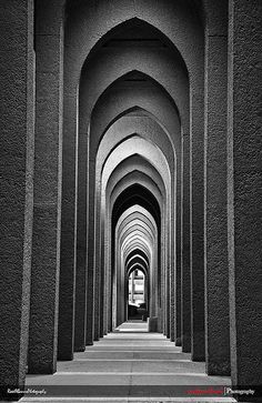 black and white photograph of an arched walkway