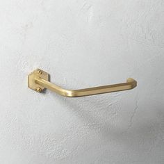 an image of a gold towel ring on the wall with white walls in the background