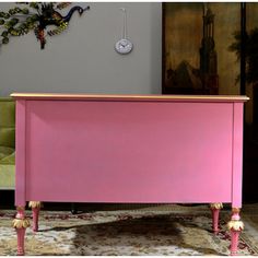 a pink dresser sitting on top of a rug