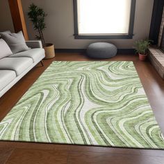 a living room filled with furniture and a rug on top of a hard wood floor