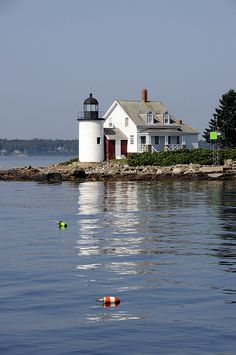 there is a light house on the water