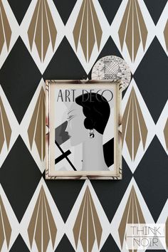 a black and white wall with an art deco frame