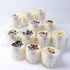 many different types of candles with labels on them