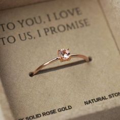 an engagement ring sitting on top of a box that says to you, i love to us, i promise