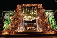 the entrance to an event decorated with lights