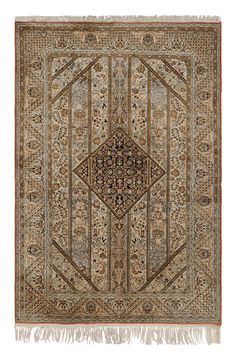 an antique rug with fringes and designs