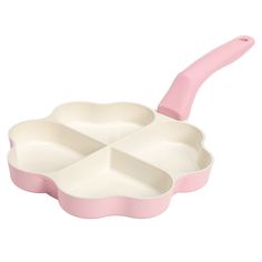 an empty pink and white pan with four sections in it, on a white background