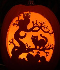 a carved pumpkin with an image of cats on it