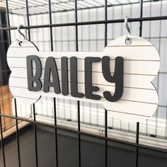 there is a sign that says bailey on the side of a metal cage in a store