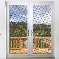 two glass doors in front of a wooden deck