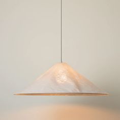 a white light hanging from a ceiling in a room