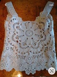 a white crocheted doily on a wooden table