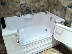 a walk in tub sitting inside of a bathroom