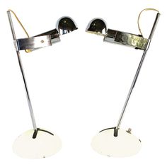 two metal lamps sitting on top of each other