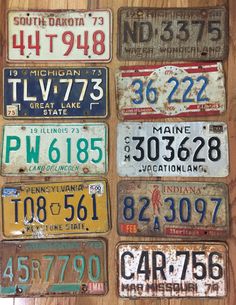 old license plates are displayed on a wooden table