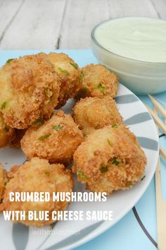 some fried food is on a plate next to a bowl of ranch dressing and dip