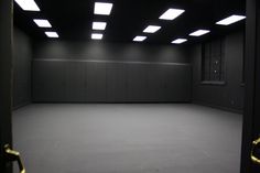 an empty room with several lights on the ceiling and no one in it at all