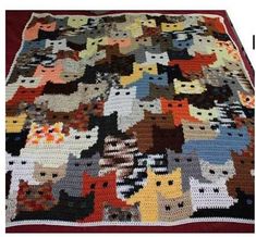 a crocheted blanket with many cats on it