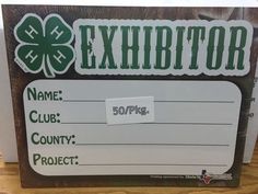 a sign that says the exhibit name, club country project and four leaf clover on it