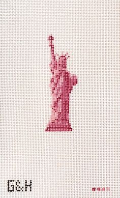 the statue of liberty cross stitched on to a white fabric with red lettering that reads, i love new york