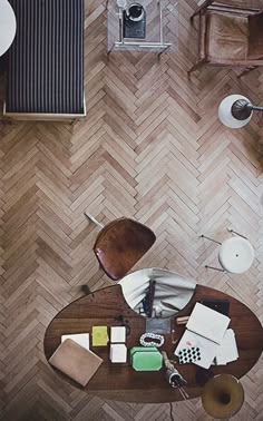 an overhead view of a living room with wood flooring and wooden furniture, including a coffee table